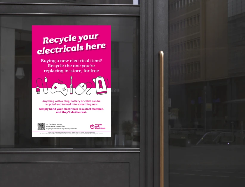 a 'recycle your electricals' poster on a shop window